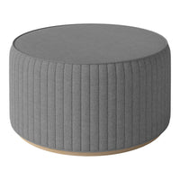 Round gray ottoman with vertical ribbed texture and a light wood base, perfect for modern decor.