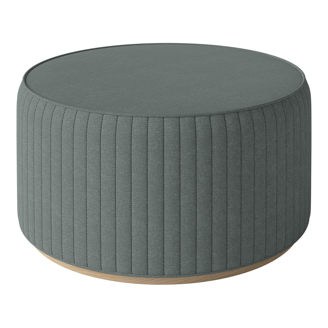 Round, ribbed ottoman in soft teal fabric with a light wood base, adding elegance to any space.