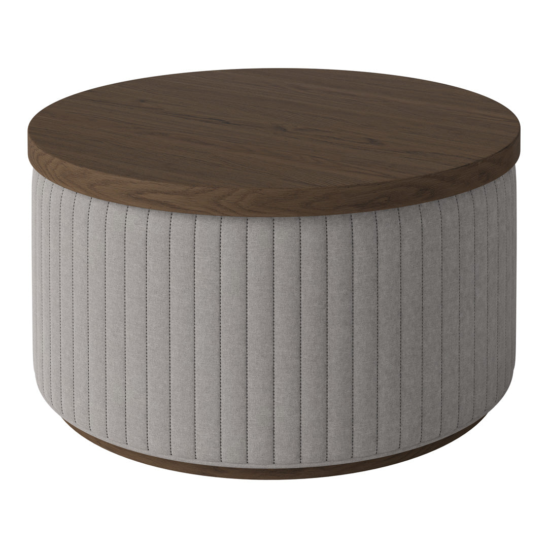 Round coffee table with a walnut top and soft gray ribbed fabric base. Modern design with a neutral color palette.