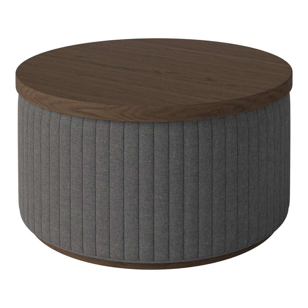 Round coffee table with a dark wood top and gray ribbed fabric base, showcasing a sleek, modern design.