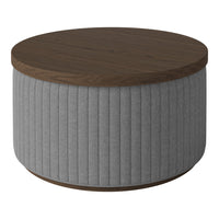 Round coffee table featuring a brown wooden top and textured gray upholstered sides with vertical ribbing pattern.