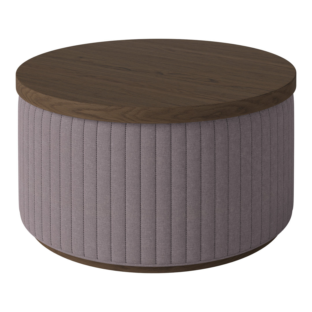 Round coffee table with a wood top and soft lavender pleated fabric base. Elegant and modern design.