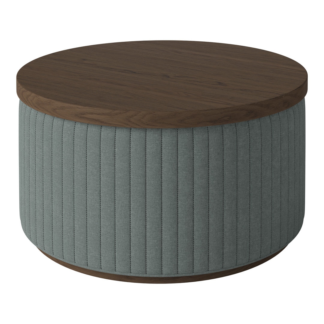 Round coffee table with a walnut top and ribbed light gray fabric base. Modern design with soft textures.