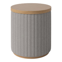 Round gray upholstered table with vertical ribbed texture and a natural wood top. Ideal for modern decor.