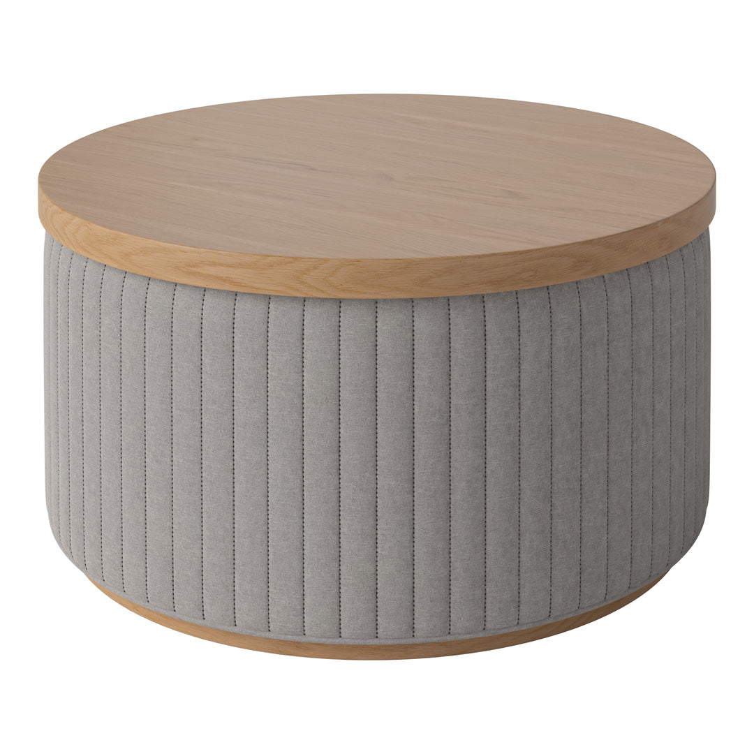 Round coffee table with a light wood top and soft gray ribbed fabric base. Stylish and modern design.