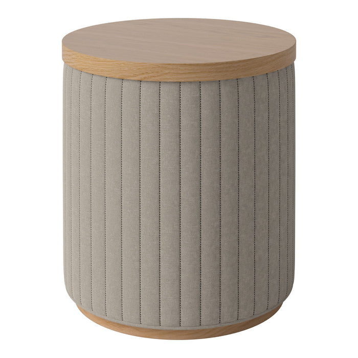 Grey upholstered round side table with vertical ribbed pattern and a natural wood top. Stylish accent piece for any room.