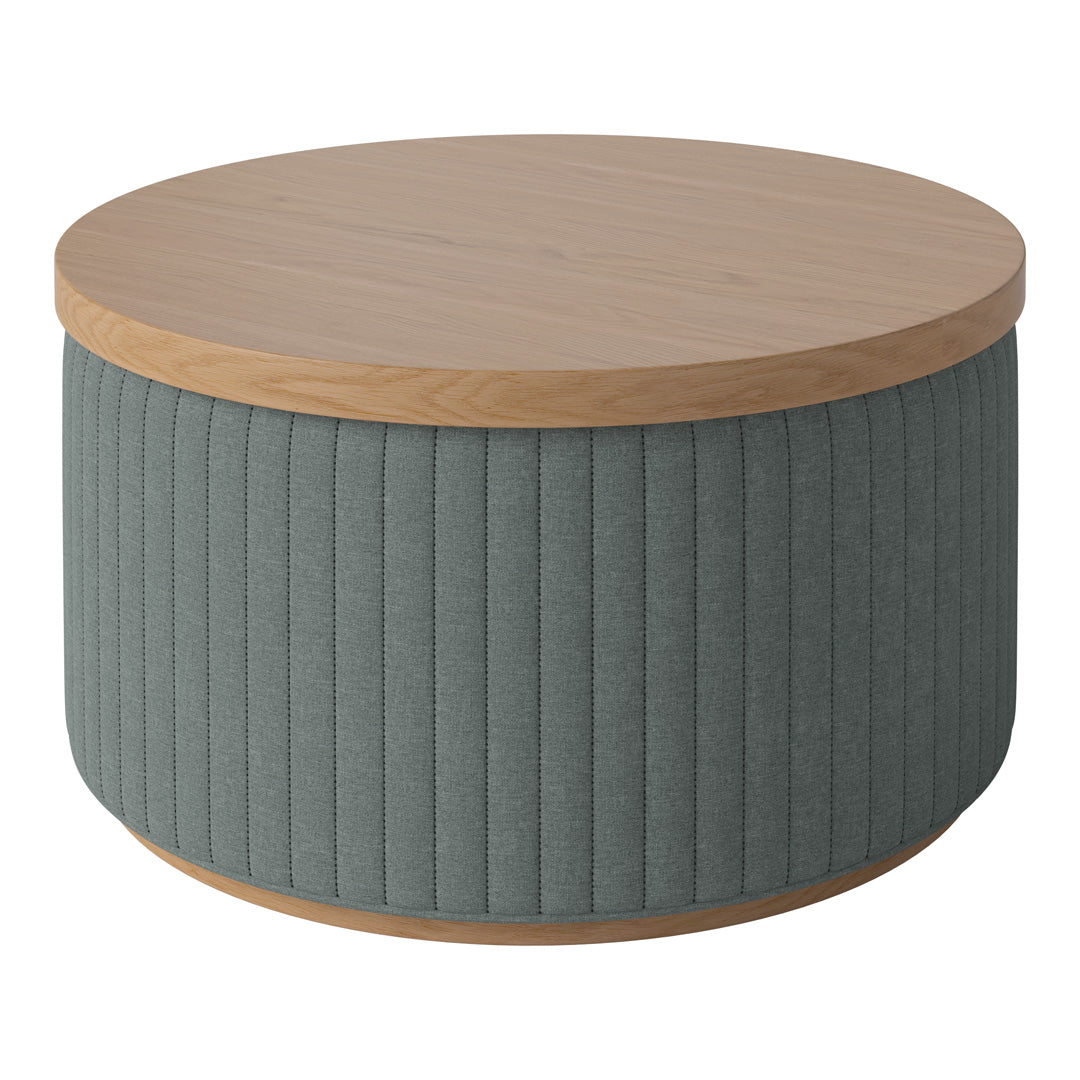 Round coffee table with a light wood top and textured gray fabric base featuring vertical patterns.