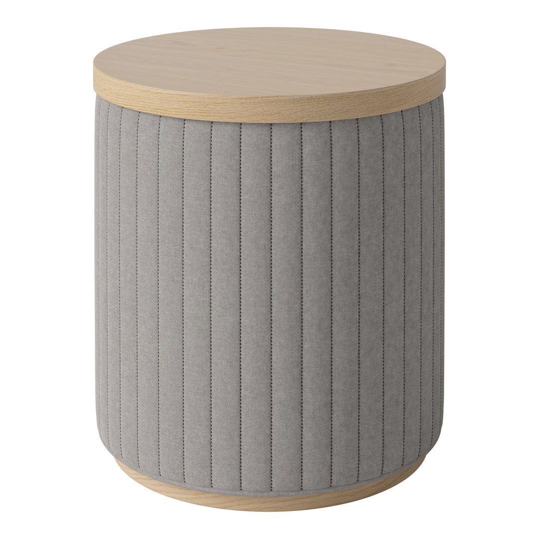 Gray upholstered round side table with vertical ribbed pattern and light wood top. Ideal for modern decor.