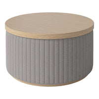 Round coffee table with a natural wood top and soft gray ribbed fabric sides for a modern, textured look.
