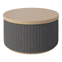 Round coffee table with a natural wood top and textured dark gray fabric side. Features vertical ribbed pattern.