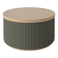 Round coffee table with light wood top and textured olive green fabric base featuring vertical ribbed pattern.