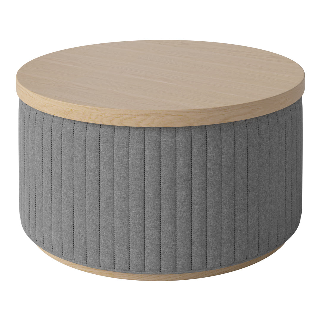Round coffee table featuring a light wood top and textured gray fabric base with vertical ribbed pattern.