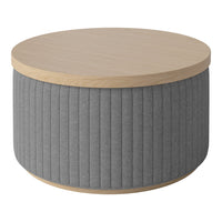 Round coffee table featuring a light wood top and textured gray fabric base with vertical ribbed pattern.