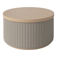 Round coffee table with light wood top and textured beige fabric base featuring vertical ribbed pattern.