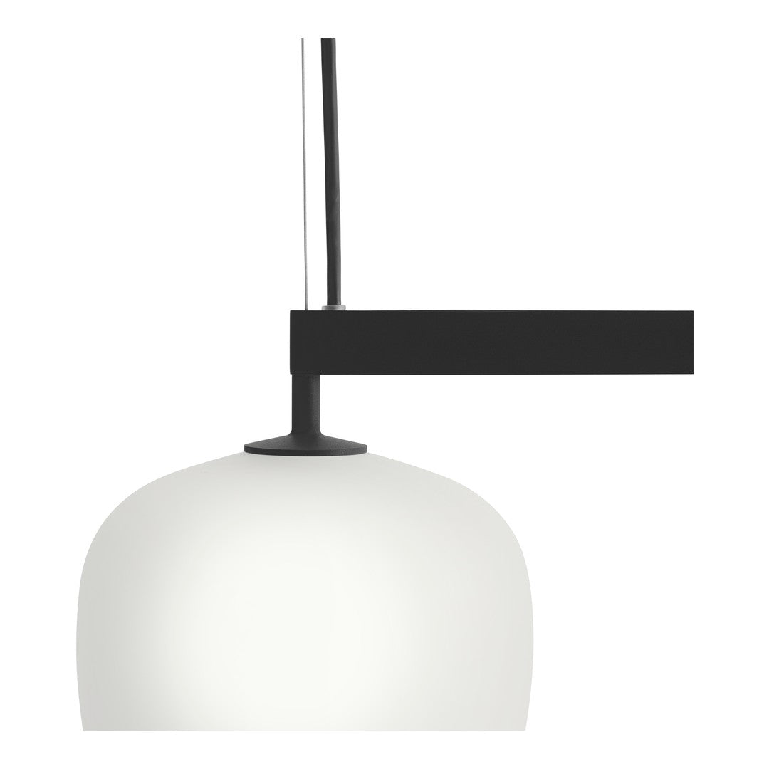 Modern black and white pendant lamp with a smooth, rounded frosted glass shade and a sleek black arm.