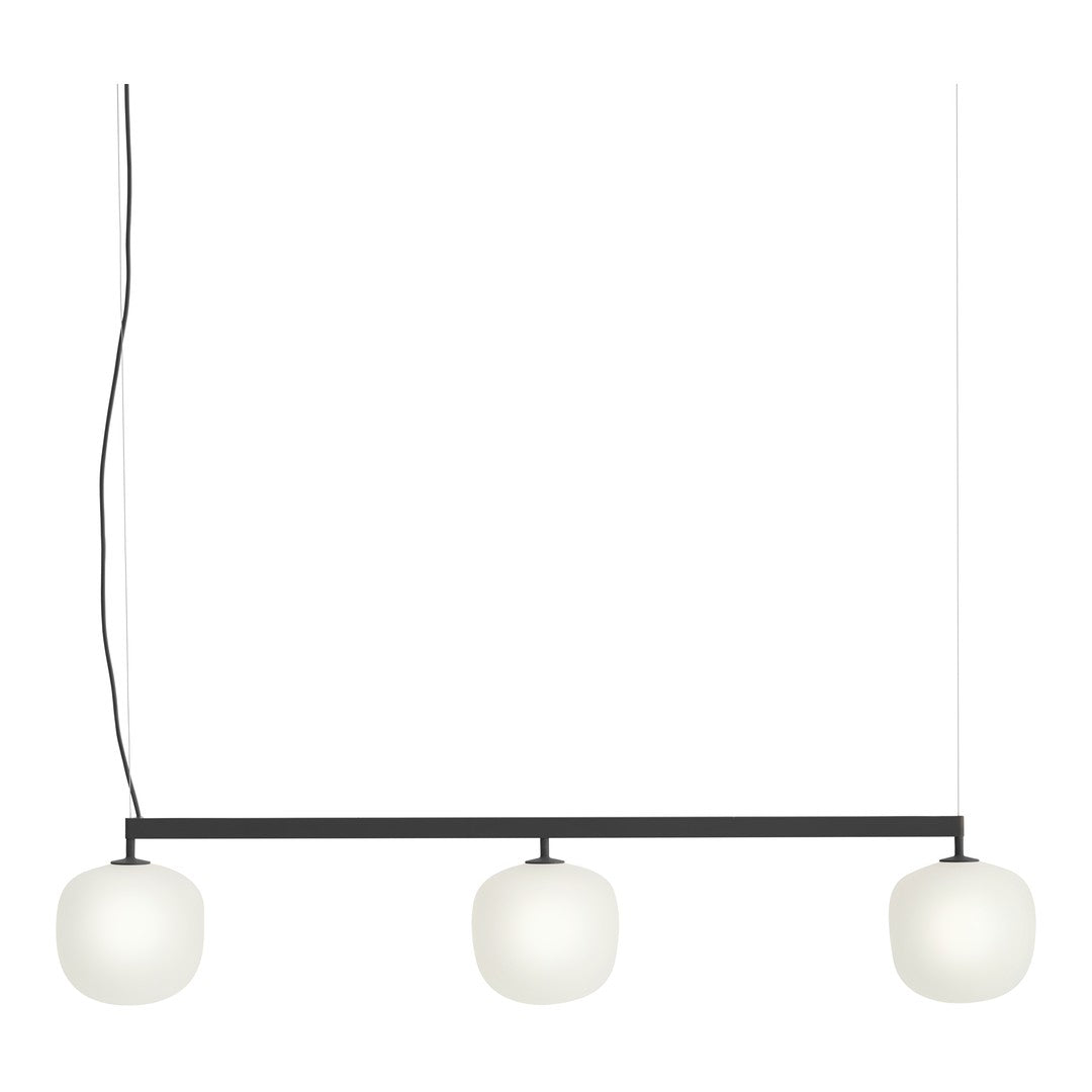 Modern pendant light with three white glass globes and a sleek black frame, perfect for contemporary decor.