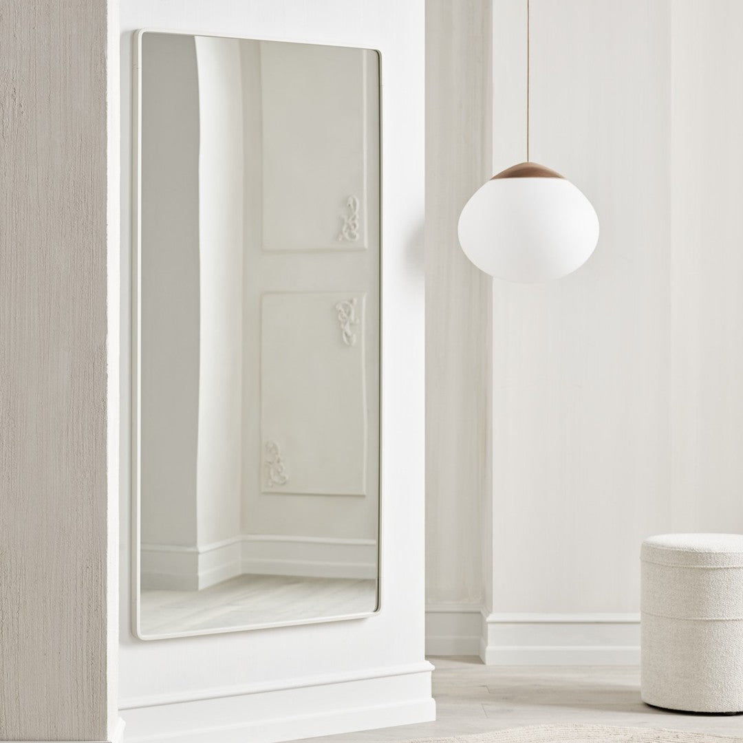 Sleek rectangular mirror with a minimalist silver frame, reflecting soft white wall and light tones.