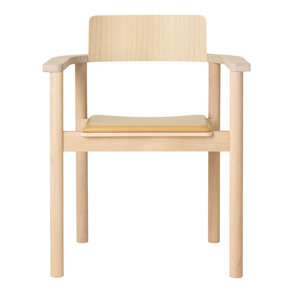Light wood chair with natural finish, featuring a minimalist design and a smooth, solid seat.