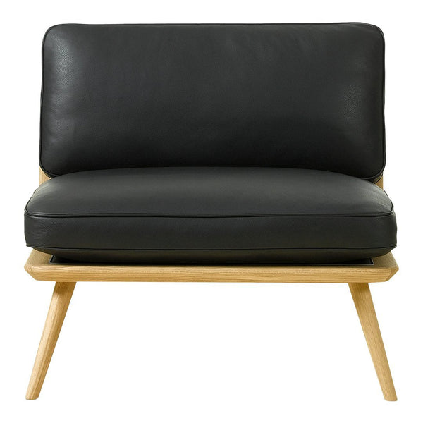 Black leather armchair with a minimalist design and natural wood legs, showcasing a sleek, modern aesthetic.