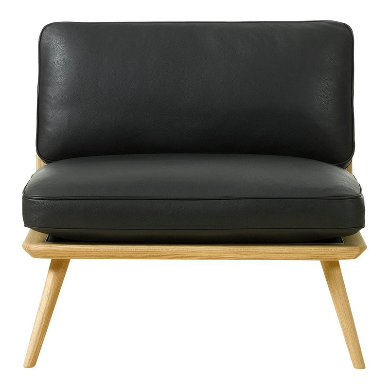 Black leather armchair with a minimalist design and natural wood legs, showcasing a sleek, modern aesthetic.