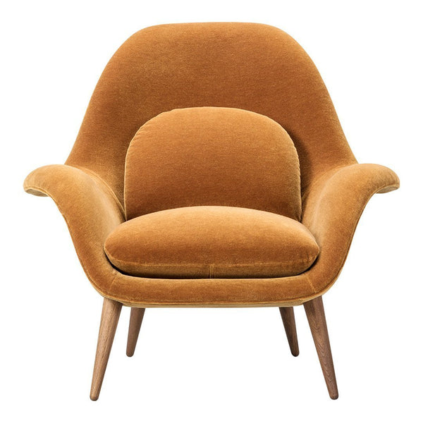 Retro-inspired chair in warm amber velvet with smooth curves and a minimalist design, featuring wooden legs.