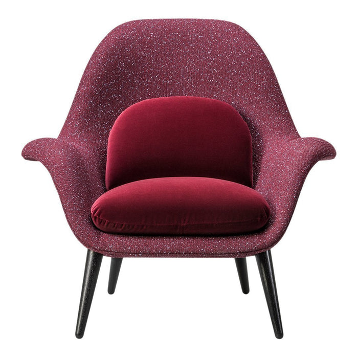 Cozy armchair in rich burgundy with a textured pattern and black legs, perfect for stylish interiors.