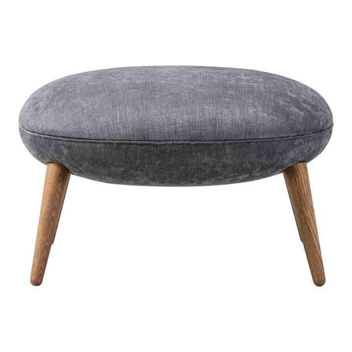 Gray upholstered ottoman with a smooth texture and natural wood legs, featuring a sleek oval shape.