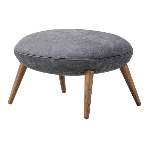 Gray upholstered ottoman with a circular shape and wooden legs, featuring a soft, textured surface.