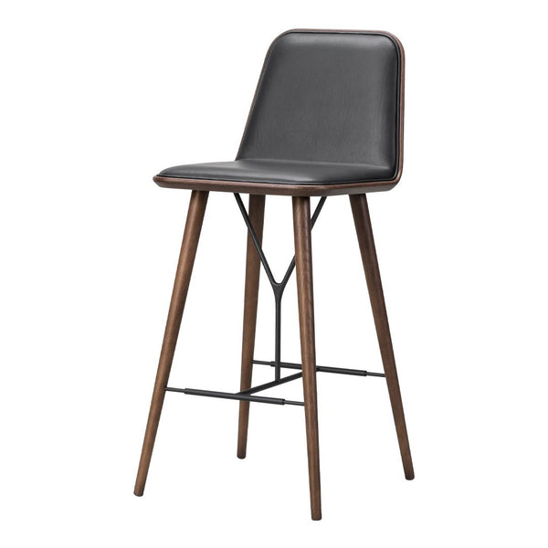 Black upholstered bar stool with wooden legs, featuring a sleek and modern design. Perfect for contemporary interiors.