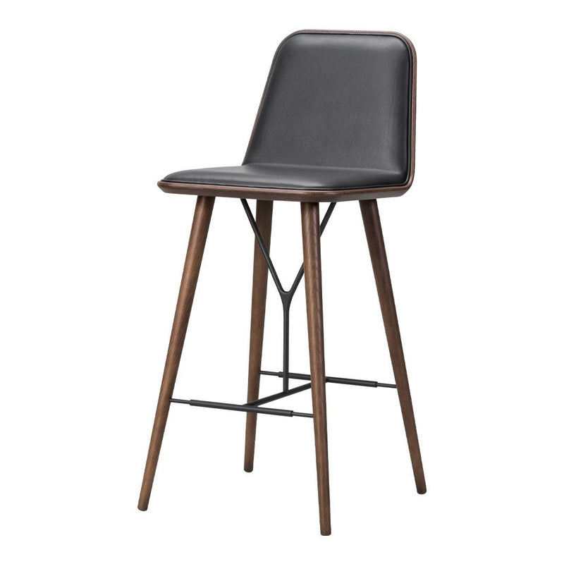Black upholstered bar stool with wooden legs, featuring a sleek and modern design. Perfect for contemporary interiors.