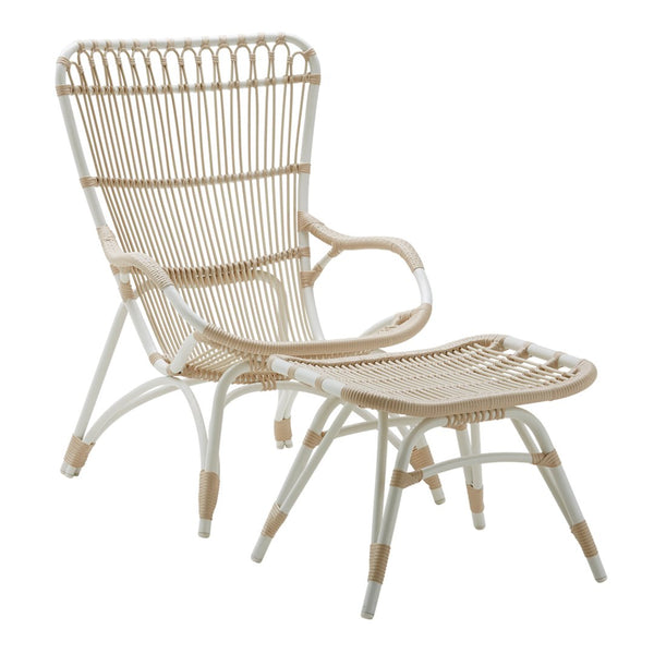 Beige and white woven rattan chair with an elegant, airy design and matching footrest, perfect for a stylish home.