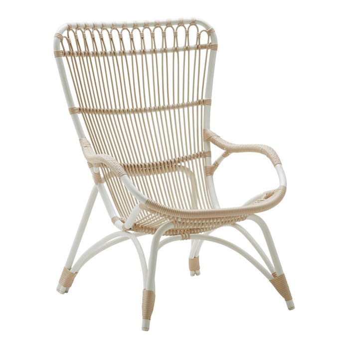 Woven rattan chair in natural tones with a white frame, showcasing a modern boho design and airy patterns.