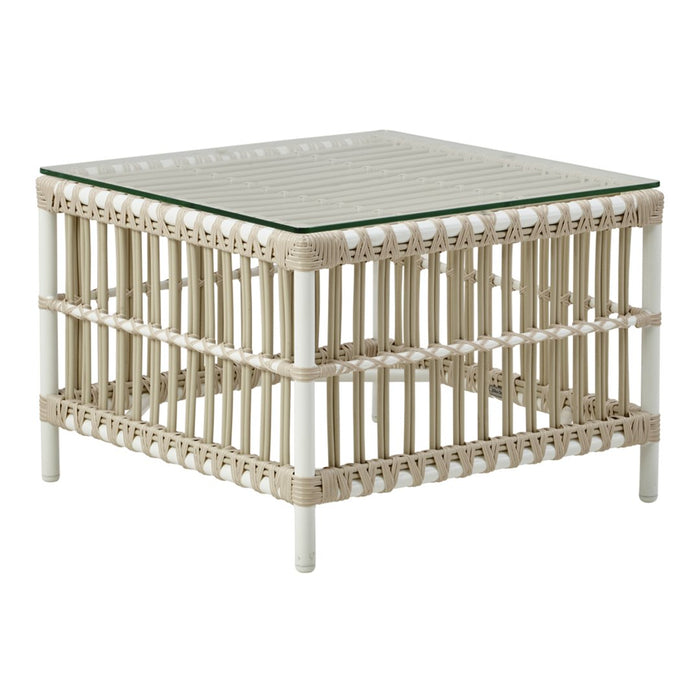 Light beige square coffee table with a slatted design and glass top, featuring intricate woven details.