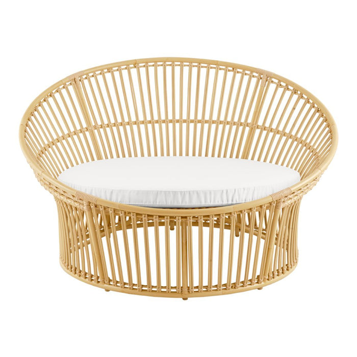 Light natural rattan chair with a round shape and white cushion, showcasing a minimalist and airy design.