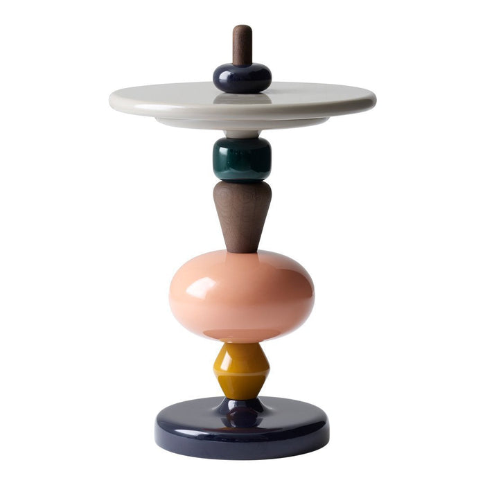 Multicolored decorative table featuring abstract shapes in pink, navy, green, brown, and yellow hues.