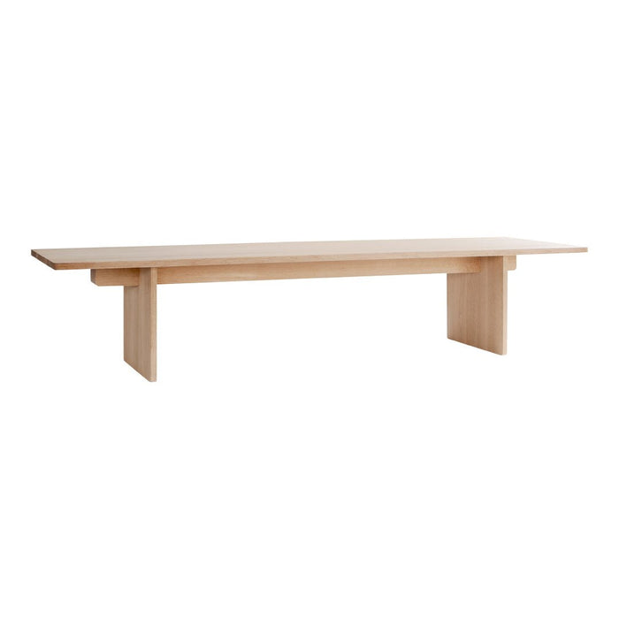 Light wood dining table with a smooth, minimalist design and clean lines, featuring a natural finish.