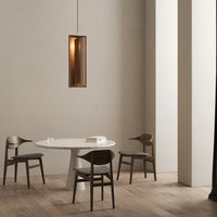"Modern dining set featuring a white marble table and dark wood chairs in a minimalist space with neutral tones."