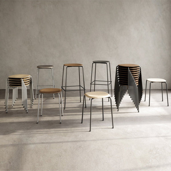 "Modern bar stools in black, white, and natural wood finishes, featuring sleek lines and minimalist design."