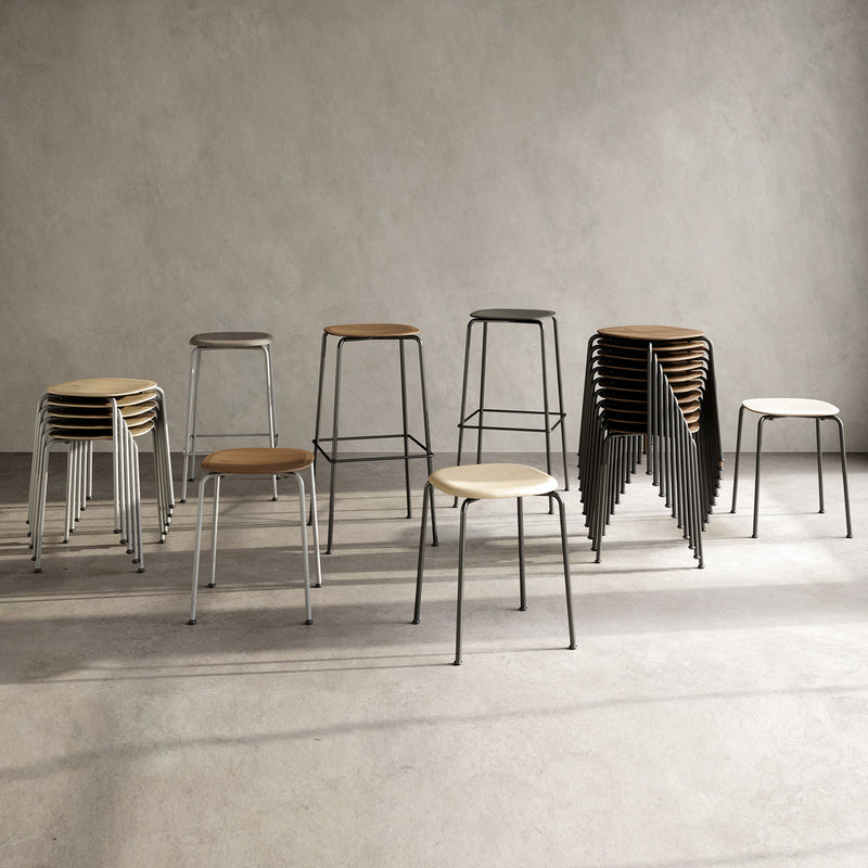 Assorted modern stools featuring beige wooden seats and sleek black and white metal frames. Stylish minimalist design.