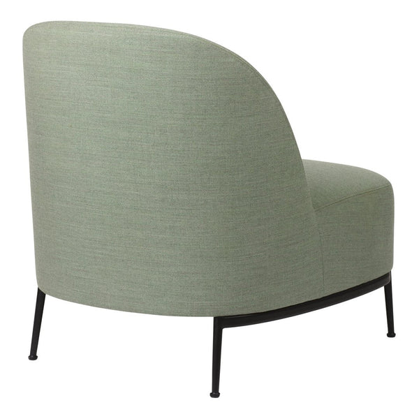 Curved accent chair in soft green fabric with subtle texture, featuring sleek black metal legs.