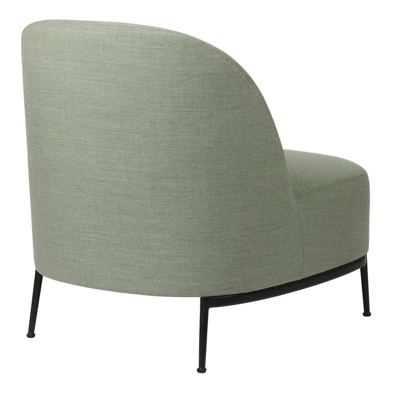 Curved accent chair in soft green fabric with subtle texture, featuring sleek black metal legs.