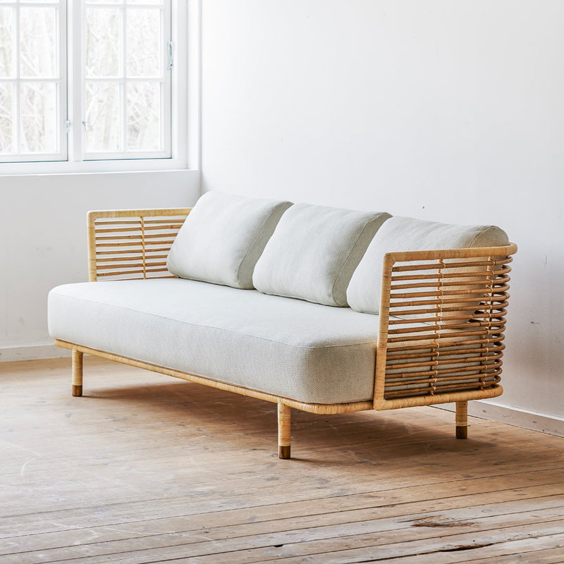 Light beige 2-seater sofa with natural rattan accents, featuring a clean, minimalist design and soft cushions.