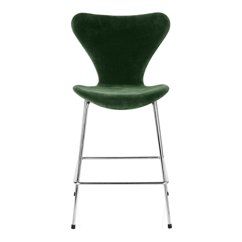 Green velvet bar chair with a sleek chrome base and smooth, modern curves. Perfect for stylish seating.