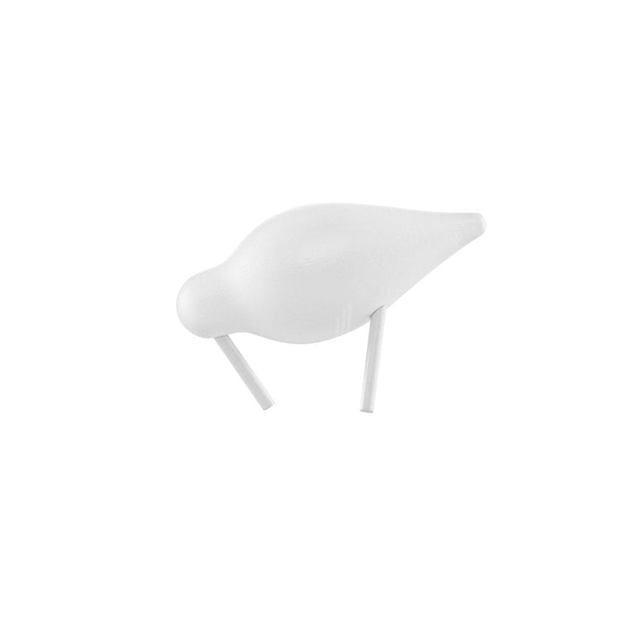 Elegant white ceramic bird figurine on a minimalist white base, perfect for modern decor.