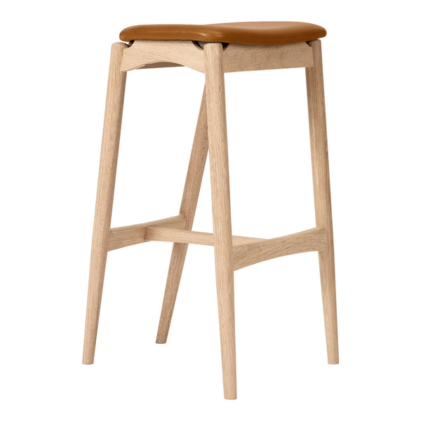 Light wood stool with a smooth tan leather seat, featuring a minimalist design and natural finish.