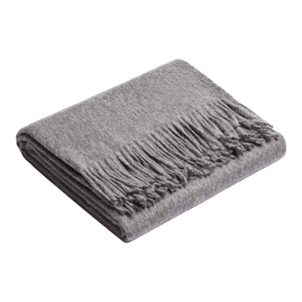 Cozy gray blanket with soft texture and stylish fringed edges, perfect for adding warmth to any space.