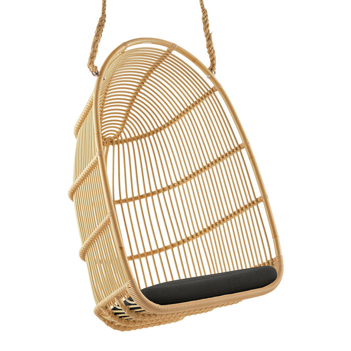 Natural woven rattan hanging chair in a sleek, minimalist design with a black cushion, featuring a geometric pattern.