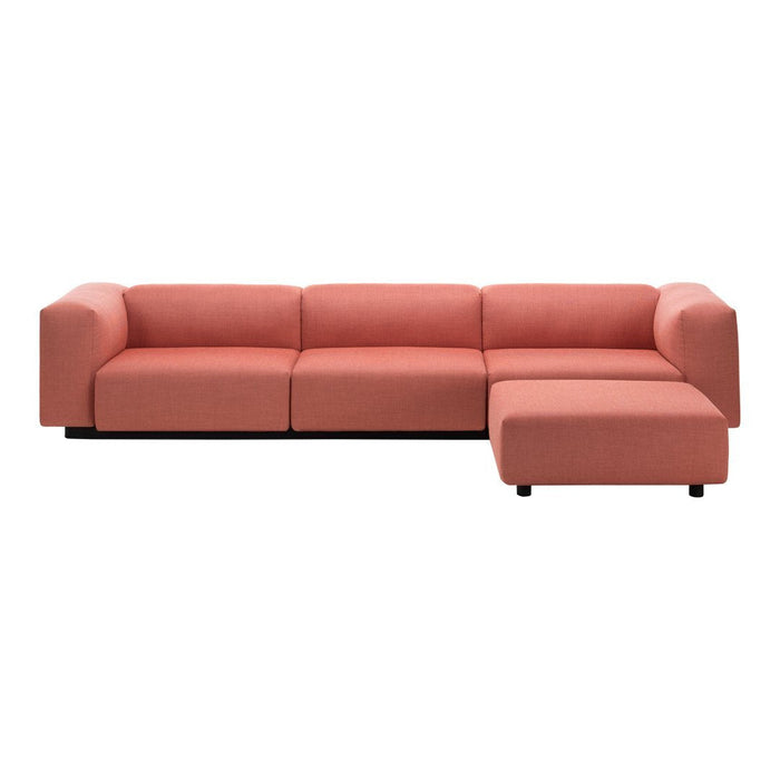 Coral pink sectional sofa with modern, minimalist design and soft fabric upholstery. Perfect for contemporary living spaces.