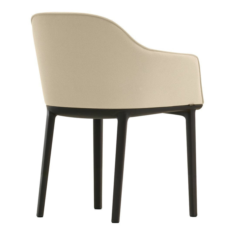 Beige upholstered chair with a curved back and dark wooden legs, showcasing a sleek, modern design.