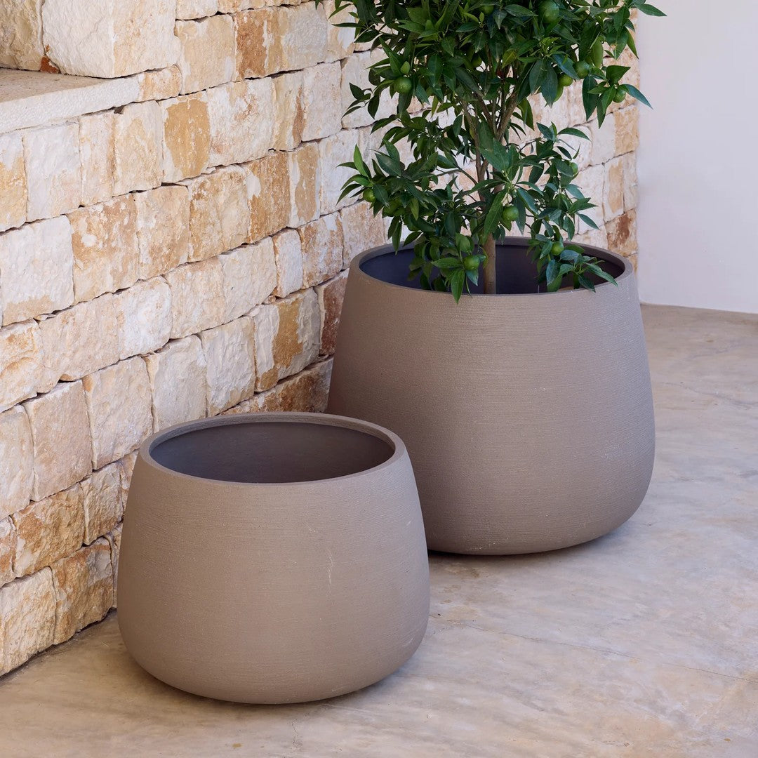Set of two textured, circular pots in soft taupe, perfect for indoor or outdoor plants. Elegant, minimalist design.